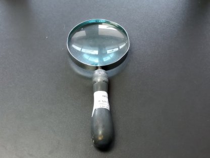 grey-handled magnifying glass